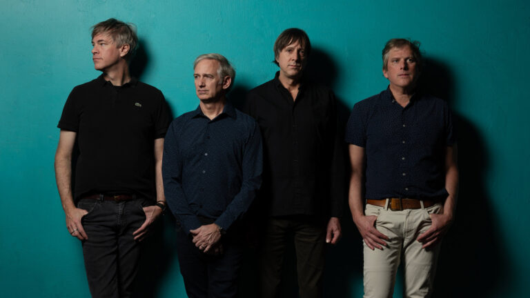 people standing in front of blue wall