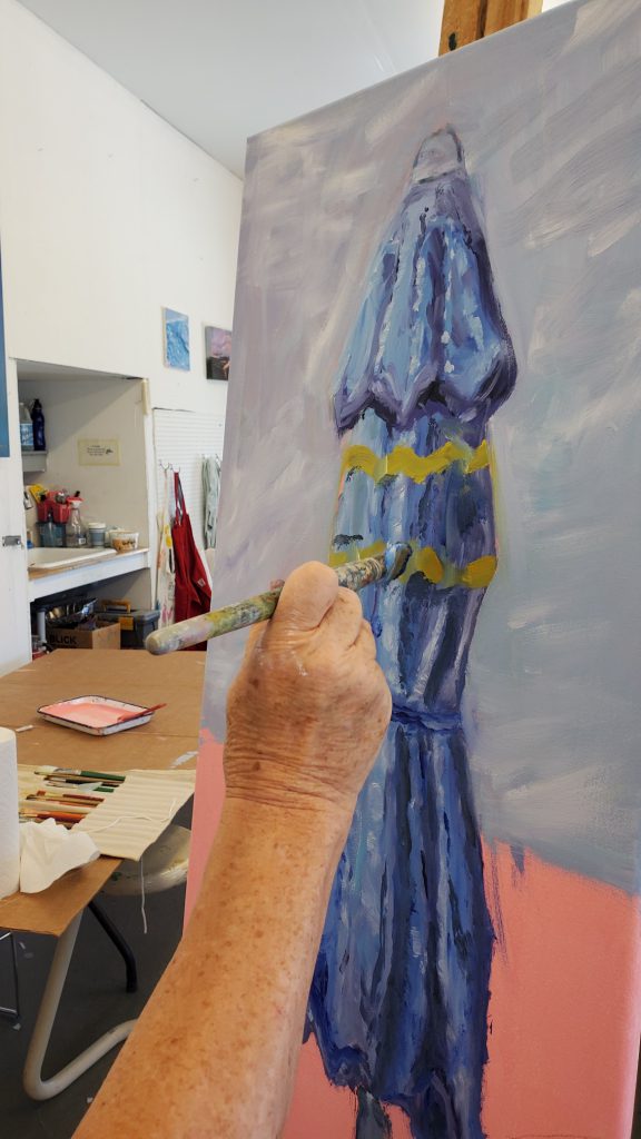 person painting an umbrella