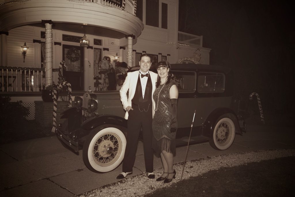 two people standing in front of car