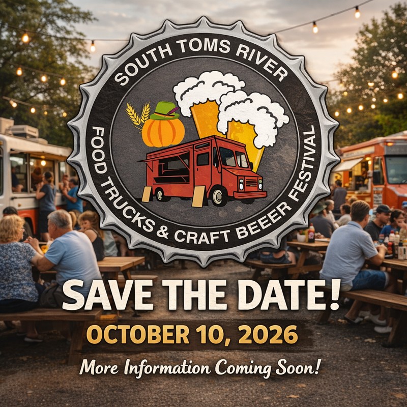 People sitting at picnic tables around food trucks