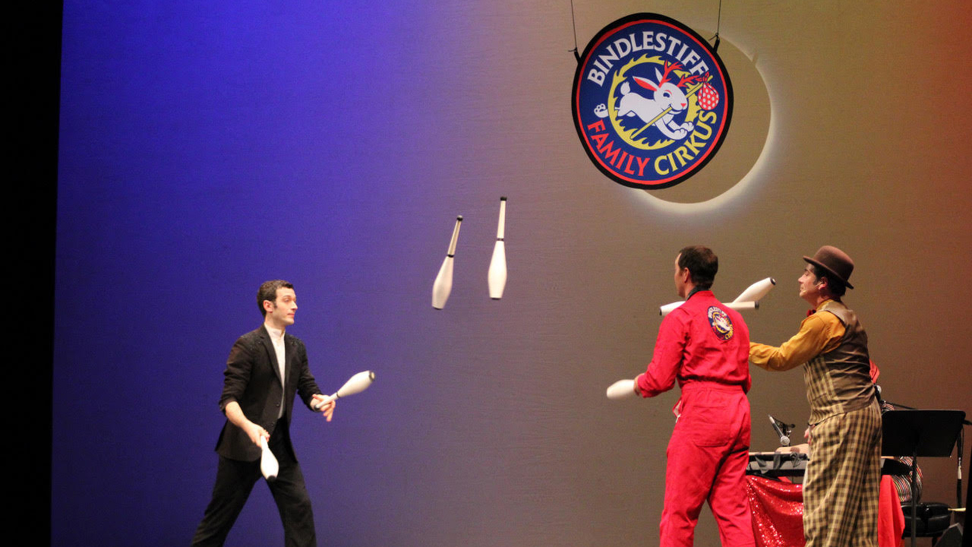 three men juggling bowling pins
