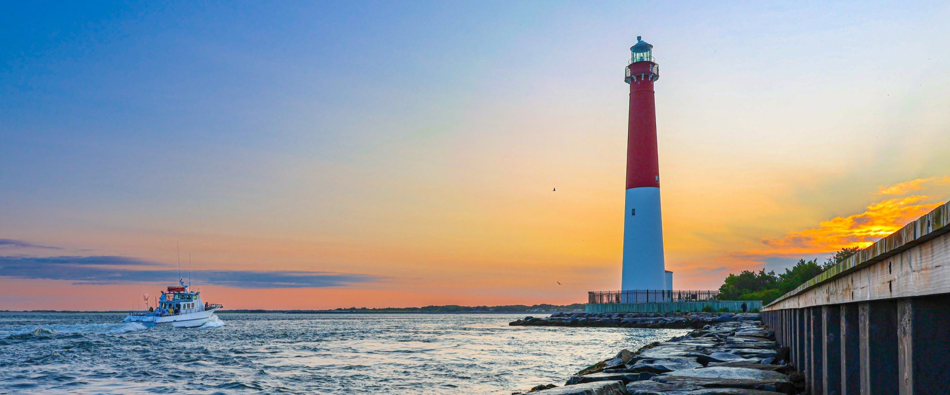 Barnegat Lighthouse and boat in the inlet