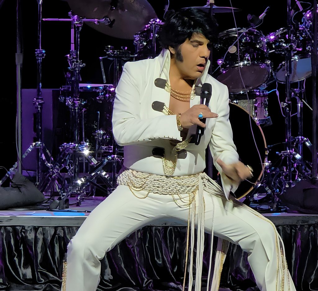 Elvis impersonator singing on stage