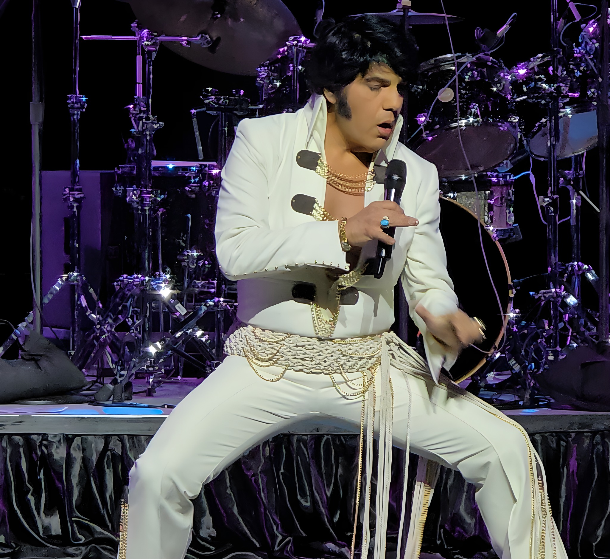 Elvis impersonator singing on stage