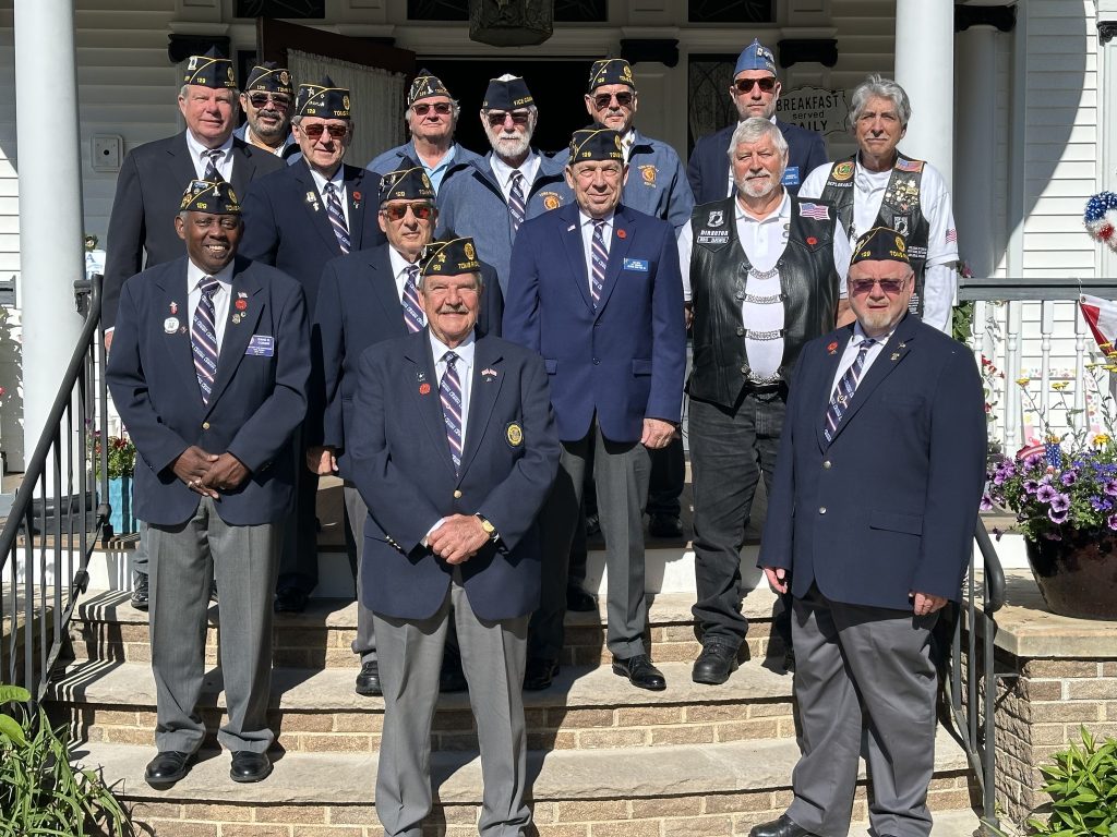 Veterans standing on the steps to the Mathis House 