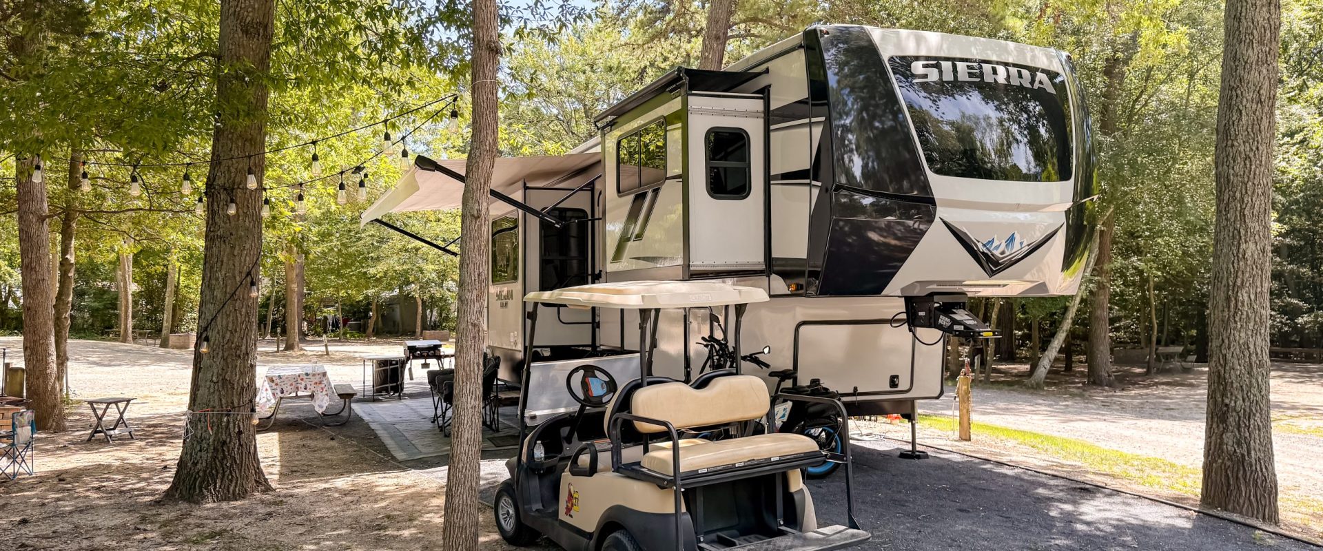IMG_2417 golf cart and camper in woods
