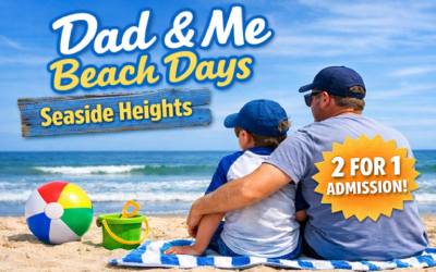 Dad and son sitting on the beach with his arm around him