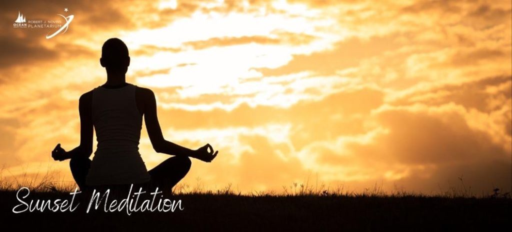 person meditating in the sunset 