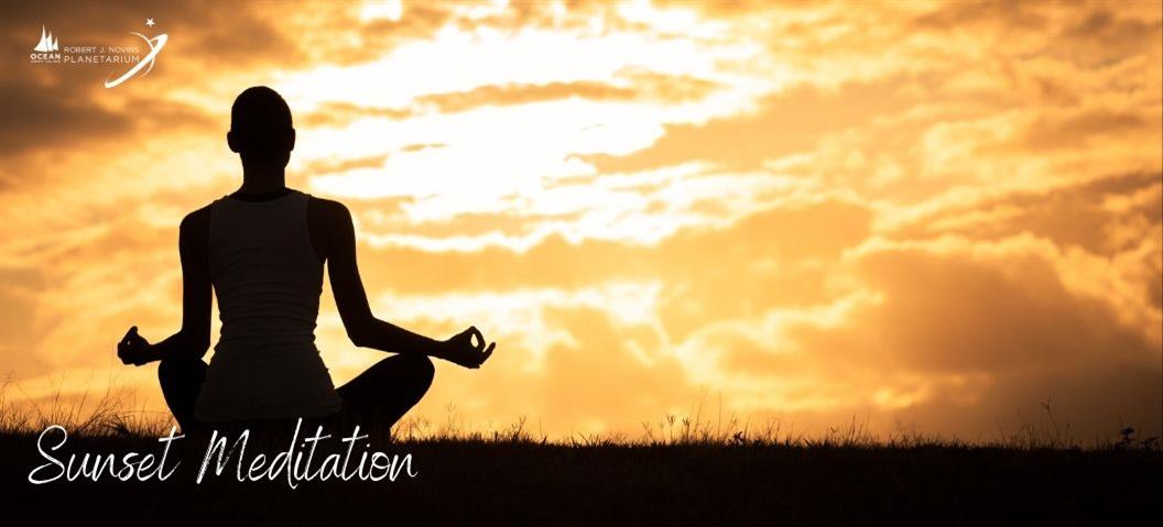 person meditating in the sunset