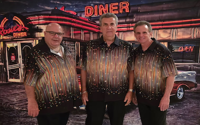 Jukebox Legends standing in front of a diner