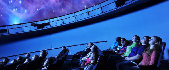 people sitting in seats at the Robert J. Novins Planetarium