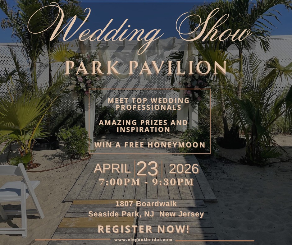 wedding arch with white sheer drape over the top and a wooden walkway. Pam trees and sand around the pathway