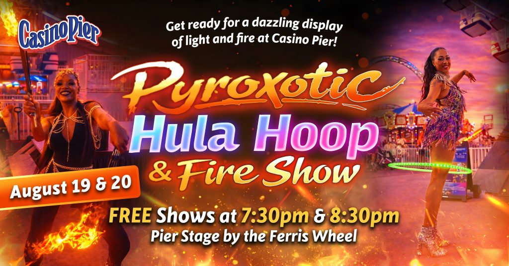 two people performing a hula hoop and fire show on the boardwalk 