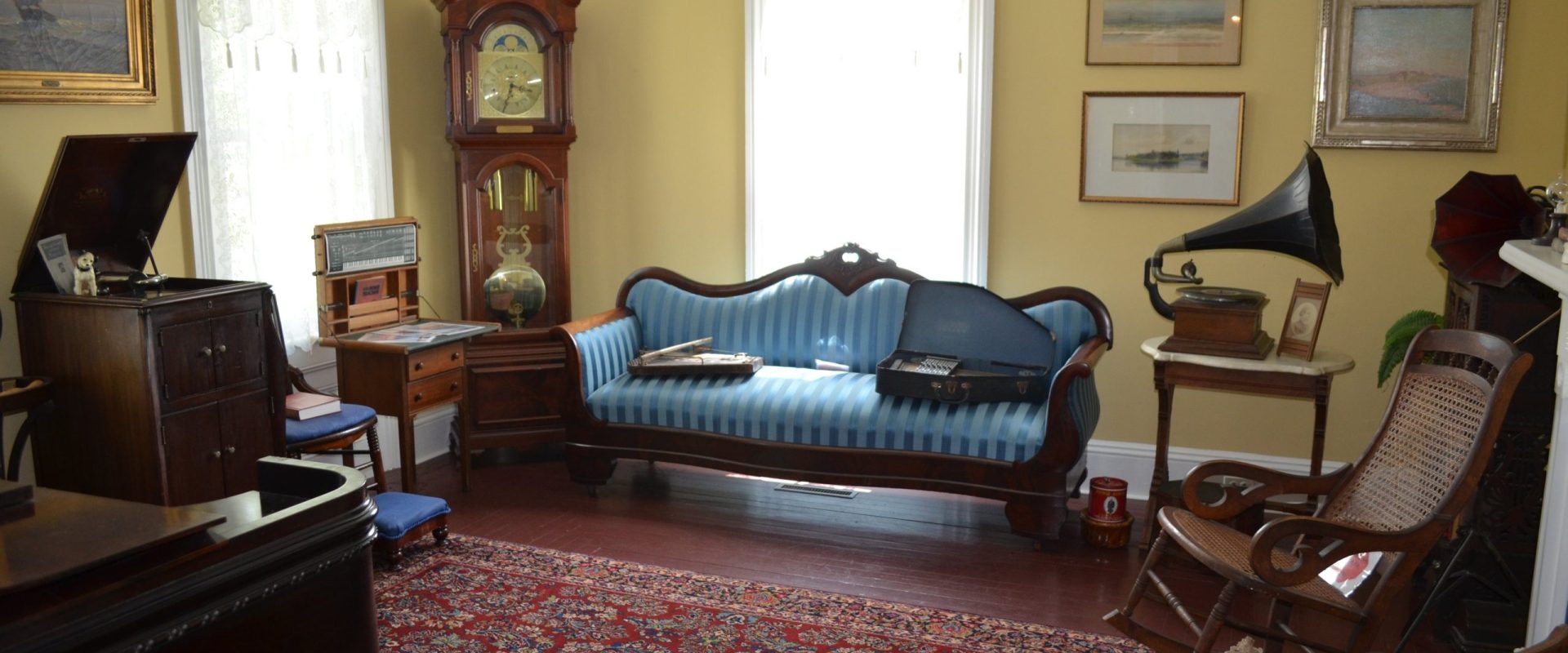 Ocean County Historical Society room with a couch. antique clock, and rug