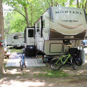 camper with a bicycle outside