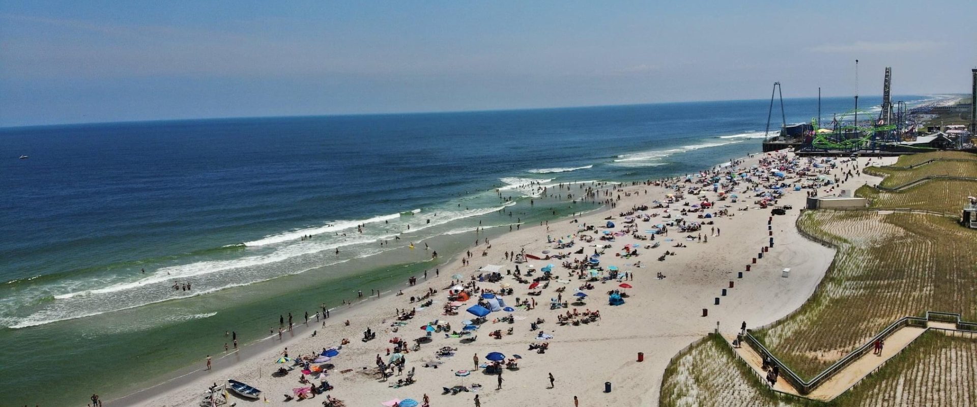 aerial photo of the beach and ocean with people on it