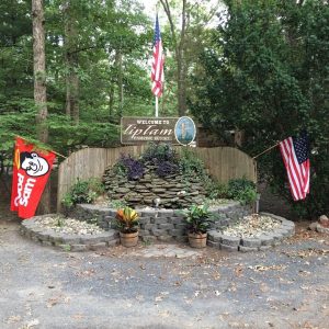 Tip Tam Camping sign with American Flags around it 