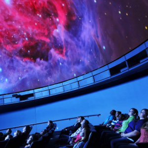 People sitting in a planetarium 