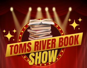 Toms River Book Show flyer with a stack of books in front of a red curtain and stage lights