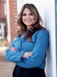 commissioner bacchione standing against a wall with her arms crossed