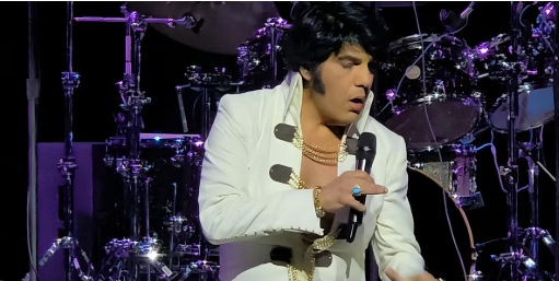 Elvis impersonator singing in a microphone