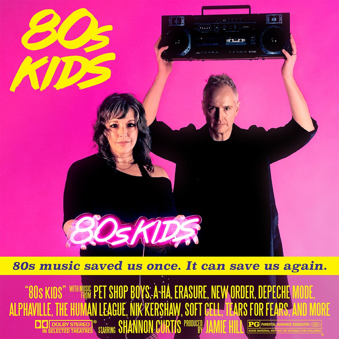 man holding a boombox and a woman standing next to him