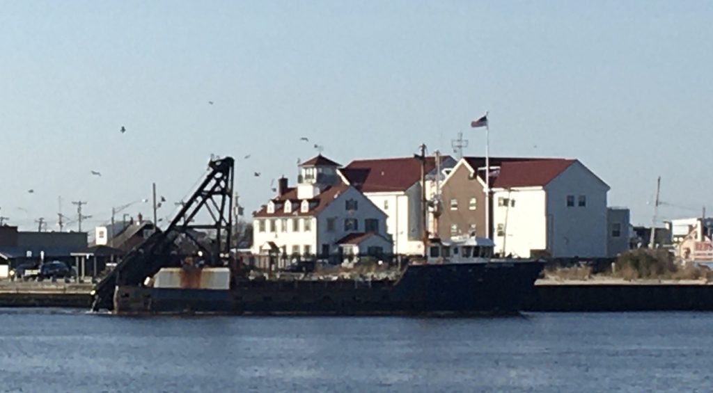 photo of a boat in the water in front of a white building