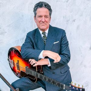 man standing with a guitar