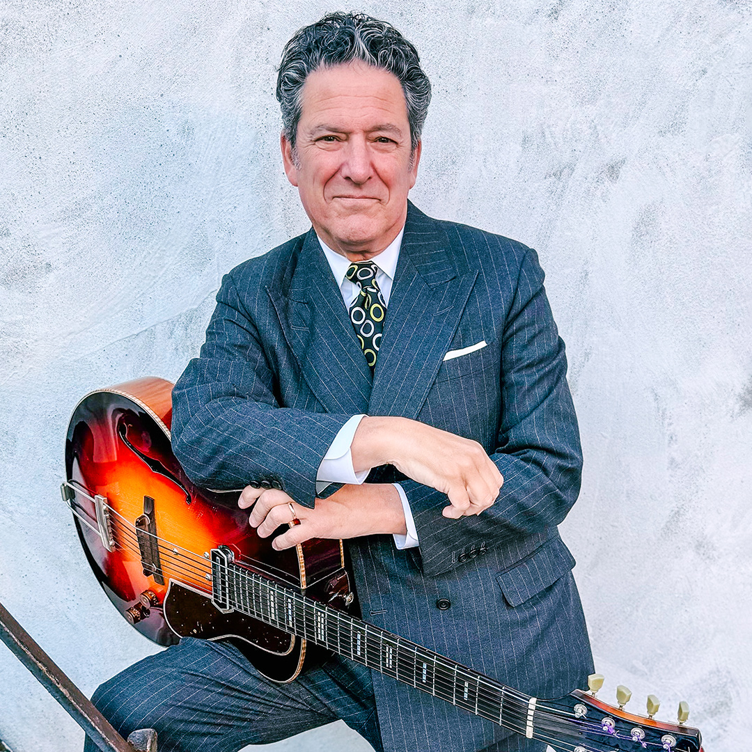 man standing with a guitar