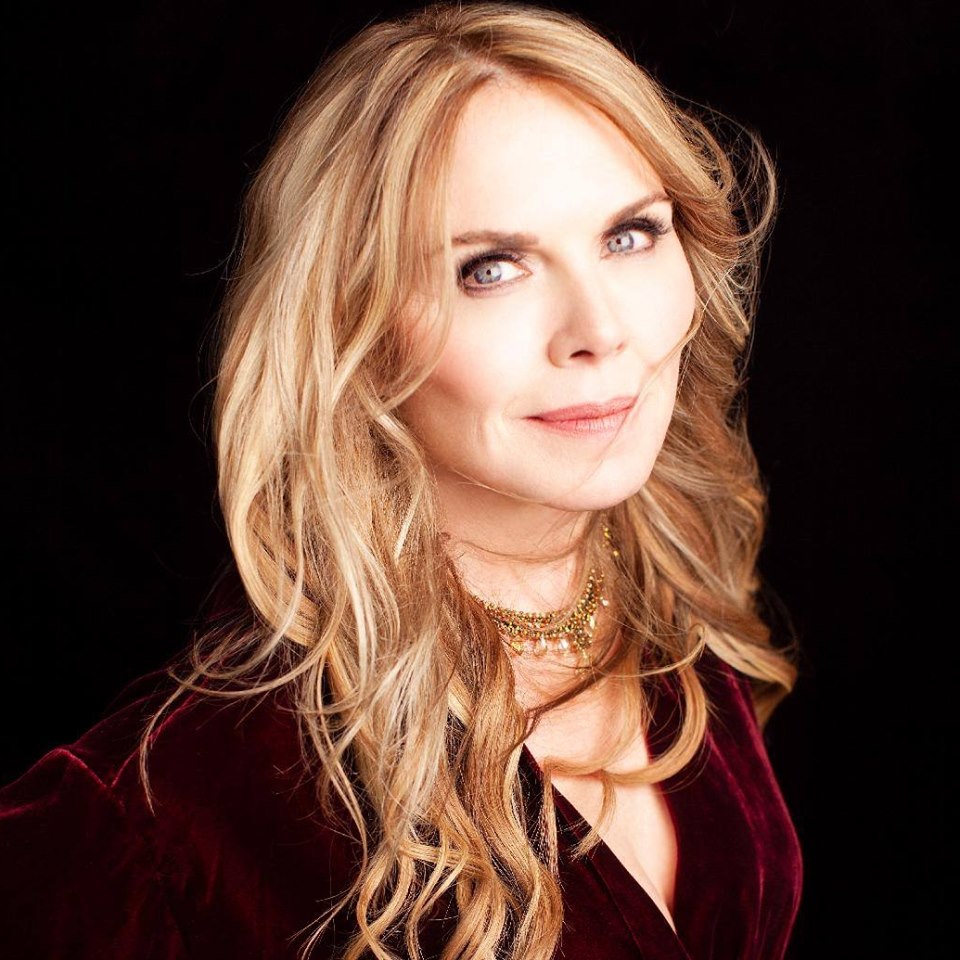 photo of a woman with blonde hair in a red velvet top