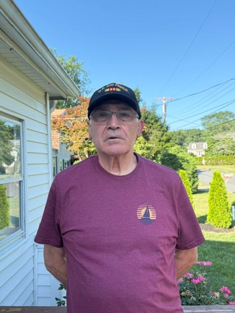 picture of a man in a red t shirt and a hat