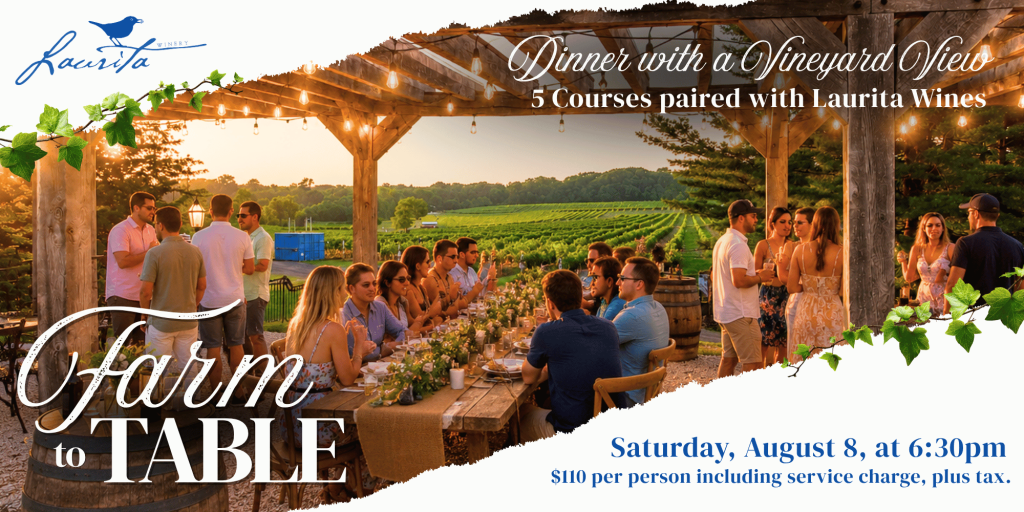 people sitting at a long table with floral arrangements eating overlooking a vineyard. People standing with drinks mingling