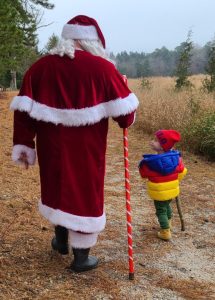 Santa Claus and a child going on a nature walk
