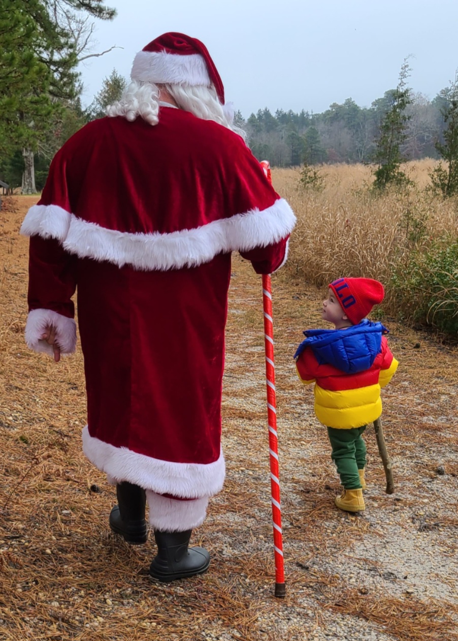 Santa Claus and a child going on a nature walk