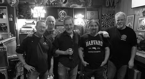 Five men standing together posing for a photo