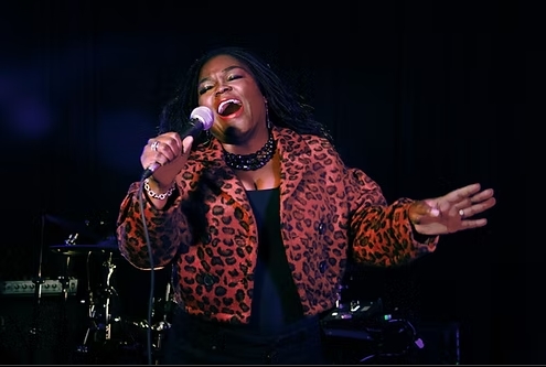 woman singing into a microphone