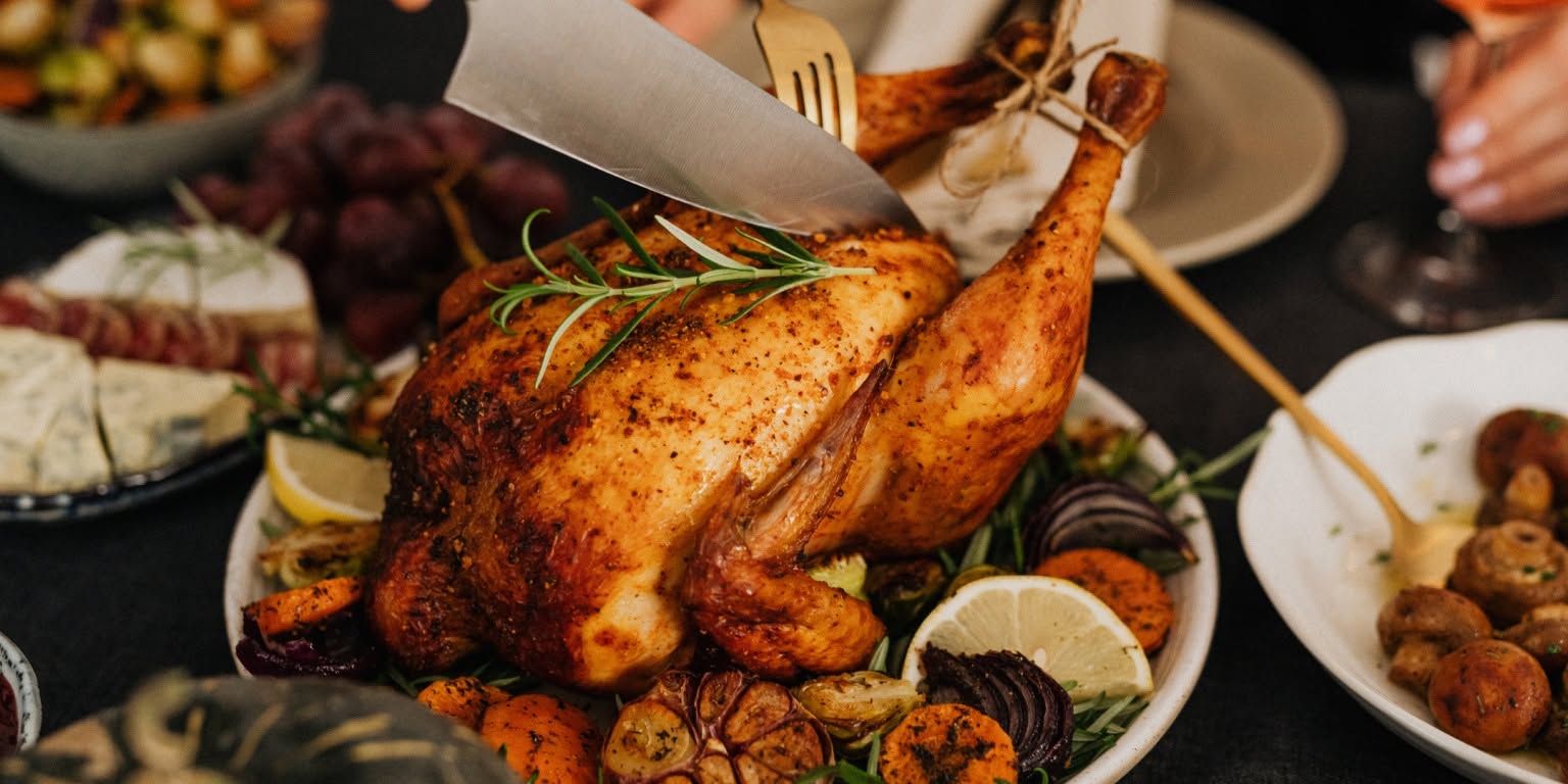 Photo of a Thanksgiving Turkey on a table with other dishes